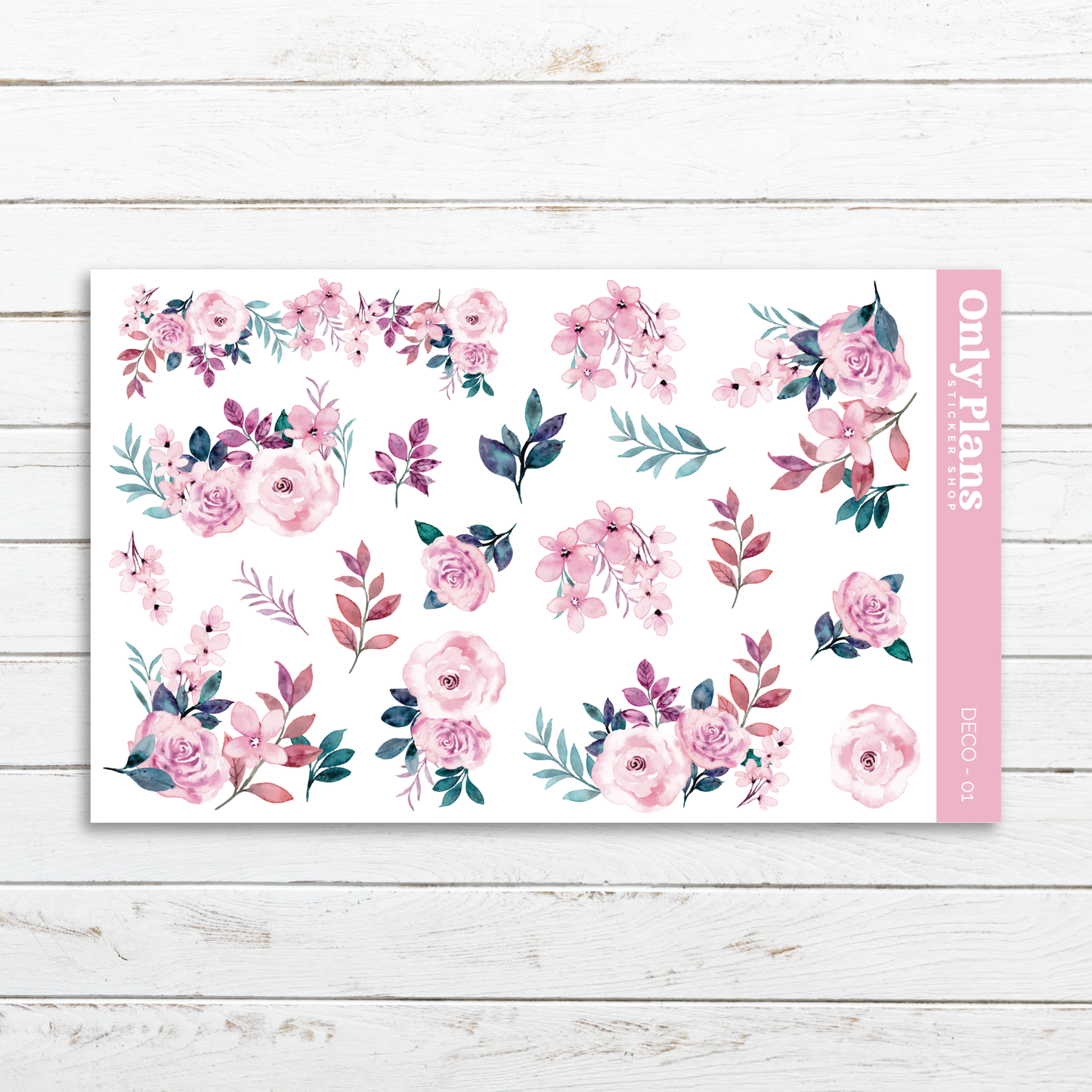 a pink floral sticker sheet on a white wooden background